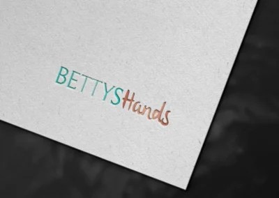 Modern logo design for Bettys Hands Pediatric Nursing Agency featuring teal and coral typography