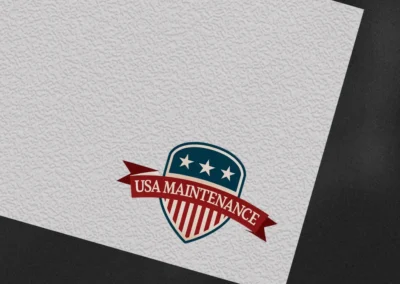Patriotic shield logo design for USA Maintenance featuring red, white, and blue elements